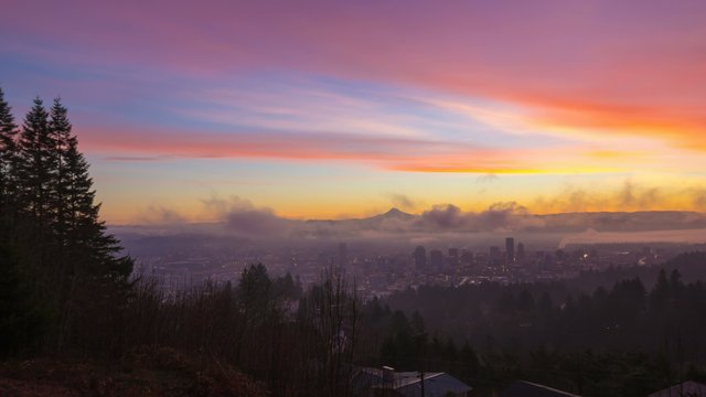 UHD Time Laspe of thick rolling fog and low clouds over city of downtown Portland Oregon and snow covered mt. hood one early morning at colorful sunrise during winter season 4096x2304