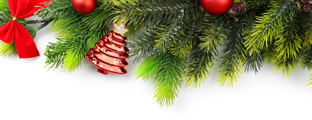 Christmas tree branch with red berries and decorations on white background