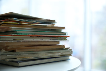 Pile of old books on white table
