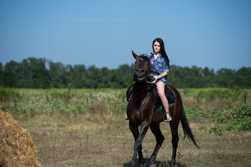 Young beautiful girl with a horse on nature