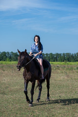 Young beautiful girl with a horse on nature