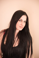 Naklejka premium portrait of a beautiful girl on a leather chair