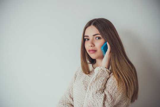 Young woman with long hair talking on the phone