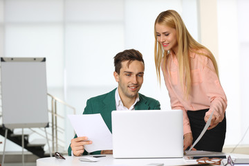 A businessman and businesswoman working in a conference room