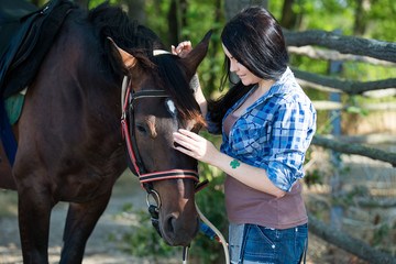 Young beautiful girl with a horse on nature