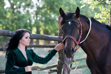 Obraz premium Young beautiful girl with a horse on nature
