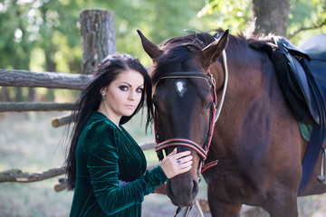 Obraz premium Young beautiful girl with a horse on nature