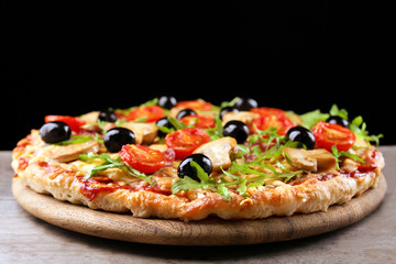 Delicious tasty pizza on black background