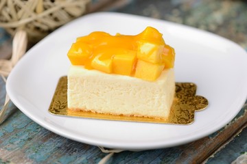 mango cheese cake with white plate background