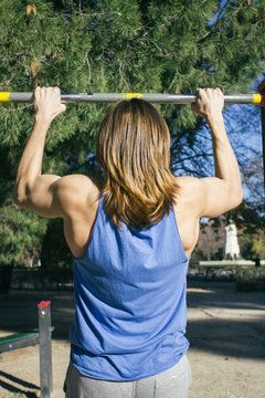Man doing pull ups during a street workout