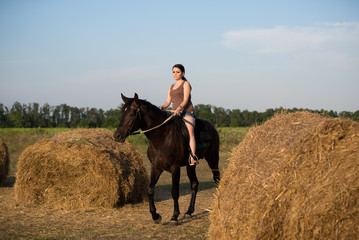 Young beautiful girl with a horse on nature