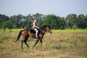 Obraz premium Young beautiful girl with a horse on nature
