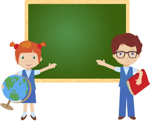 Boy and girl standing near the blackboard in a classroom