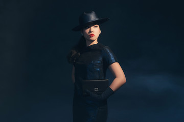 Stylish retro 1940 asian fashion woman. Holding handbag. Wearing