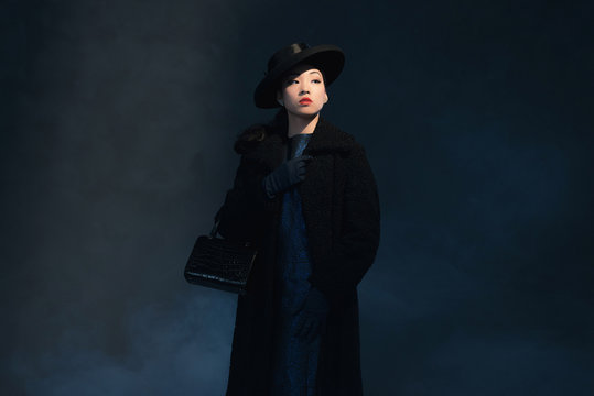 Upperclass retro 1940 asian fashion woman. Holding handbag. Wear