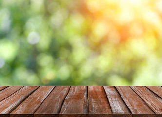 Wood table top on green bokeh and lens flare background