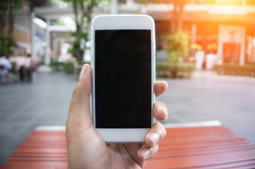 Man's hand shows mobile smartphone in vertical position