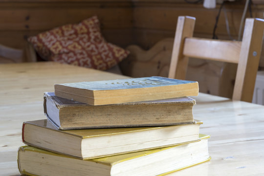 Pile of old books on a rustic table