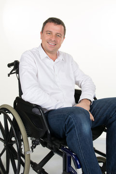 Happy man in a wheelchair isolated on a white background