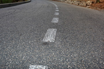 Paved road with dividing line. Focus on foreground