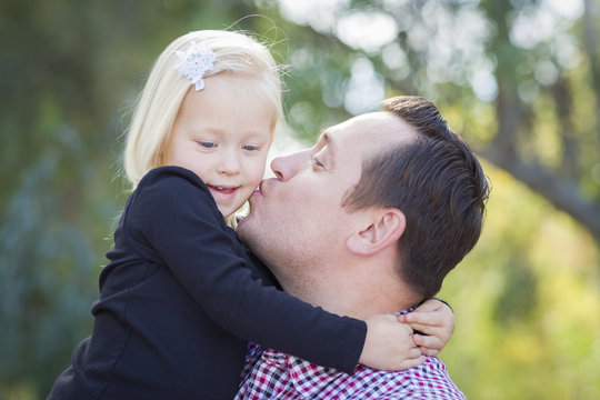 Father Kissing Adorable Little Girl Outdoors