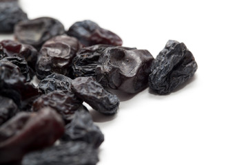 Black raisins on a white background. macro