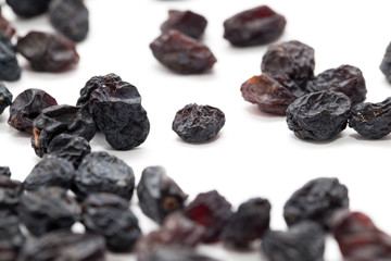 Black raisins on a white background. macro