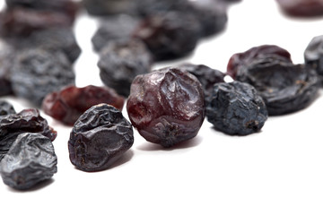 Black raisins on a white background. macro