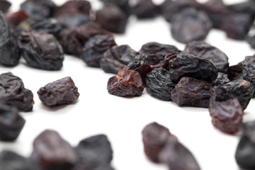 Black raisins on a white background. macro
