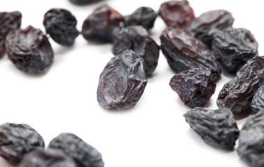 Black raisins on a white background. macro