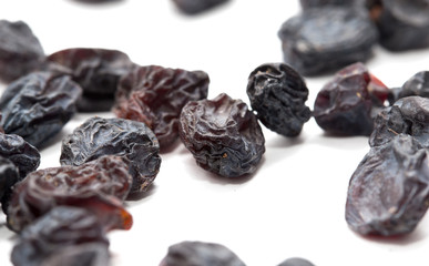 Black raisins on a white background. macro