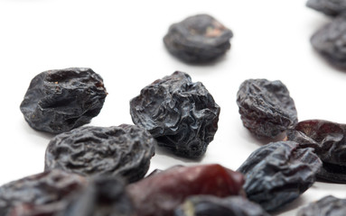 Black raisins on a white background. macro