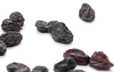 Black raisins on a white background. macro