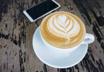 Cups of latte art coffee on wood table