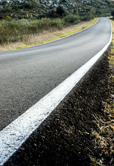 Road amongst the mountains at sunset