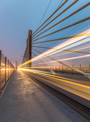 Fototapeta premium Tram lights trails on tram cable-stayed bridge in Krakow, Poland