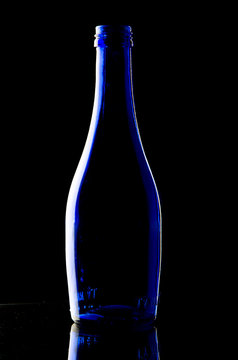 Blue bottle on black background