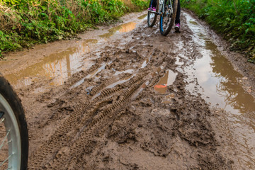 Bicycle ride through muddy dirt road
