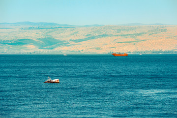 Obraz premium Brown wooden boat sailing in Sea of Galilee 