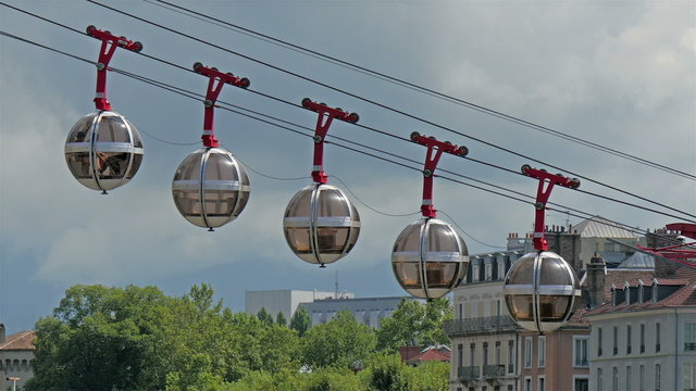 Closer look of the five cable cars capsules going down from the Grenoble mountain alps