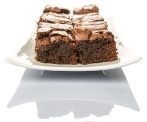 Homemade brownies in white plate over white background