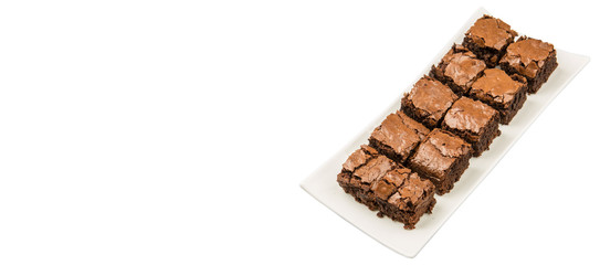 Homemade brownies in white plate over white background