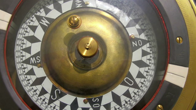 A huge compass inside the captains deck. A compass is an instrument used for navigation and orientation that shows direction relative to the geographic cardinal directions