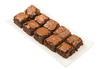 Homemade brownies in white plate over white background