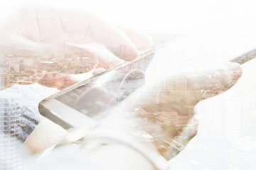 Double exposure of cityscape and smart phone, communication technology concept.