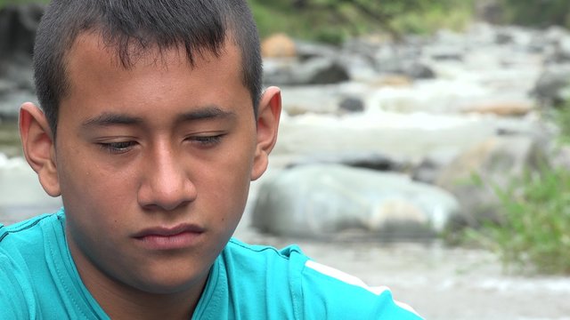 Teenage Boy sad near River