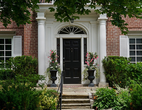 front door with portico entrance and flagstone steps