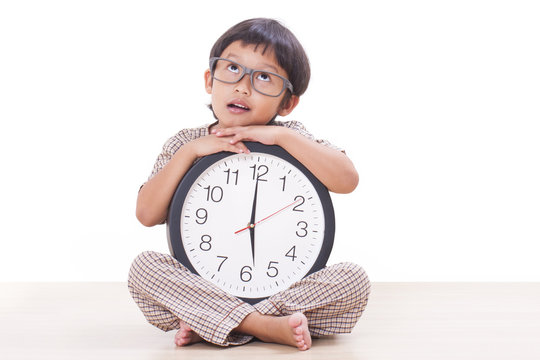 Cute boy is holding big clock 