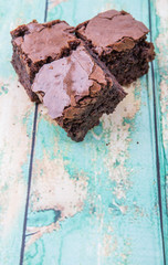 Homemade chocolate brownies over wooden background