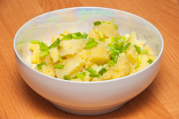 Boiled potatoes with green onion. Natural dish. Hot potatoes in
